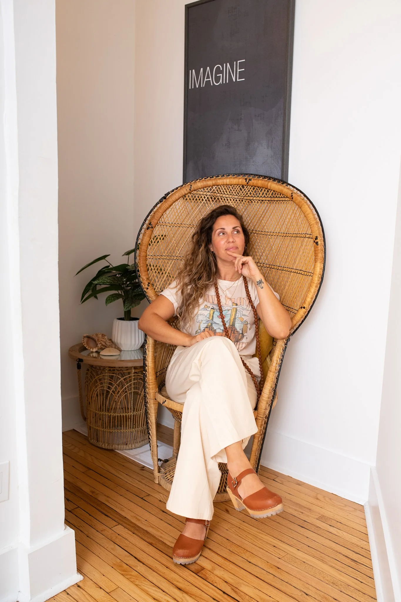 Kristina seated in a peacock chair